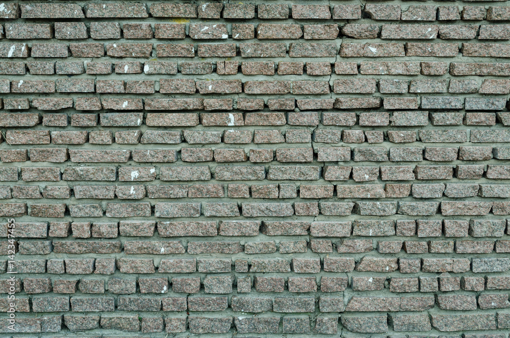 A wall made of layers of gray granite small A wall made of layers of gray granite small