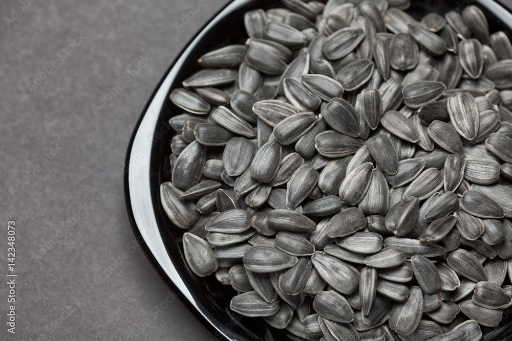 Sunflower seeds in a black plate Sunflower seeds in a black plate