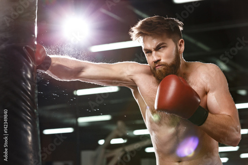 Emotional concentrated young strong sports man boxer