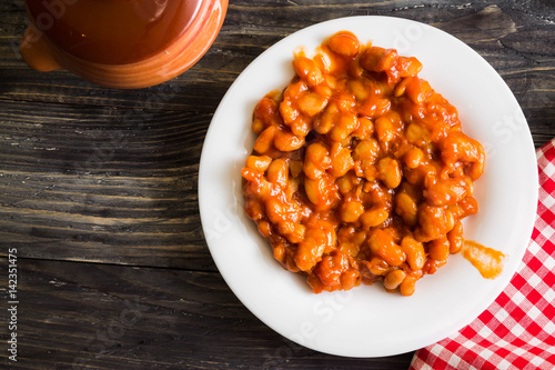 Beans in tomato in a white plate. A delicious dish.