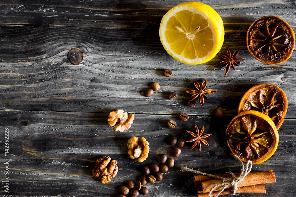 Dried slices of lemon, coffee beans, dried fruits and nuts on a wooden table. Natural product. Dried slices of lemon, coffee beans, dried fruits and nuts on a wooden table. Natural product.