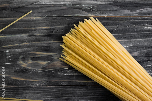 Dried spaghetti on a wooden table in rustic style