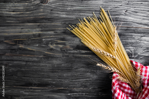 Dried spaghetti on a wooden table in rustic style