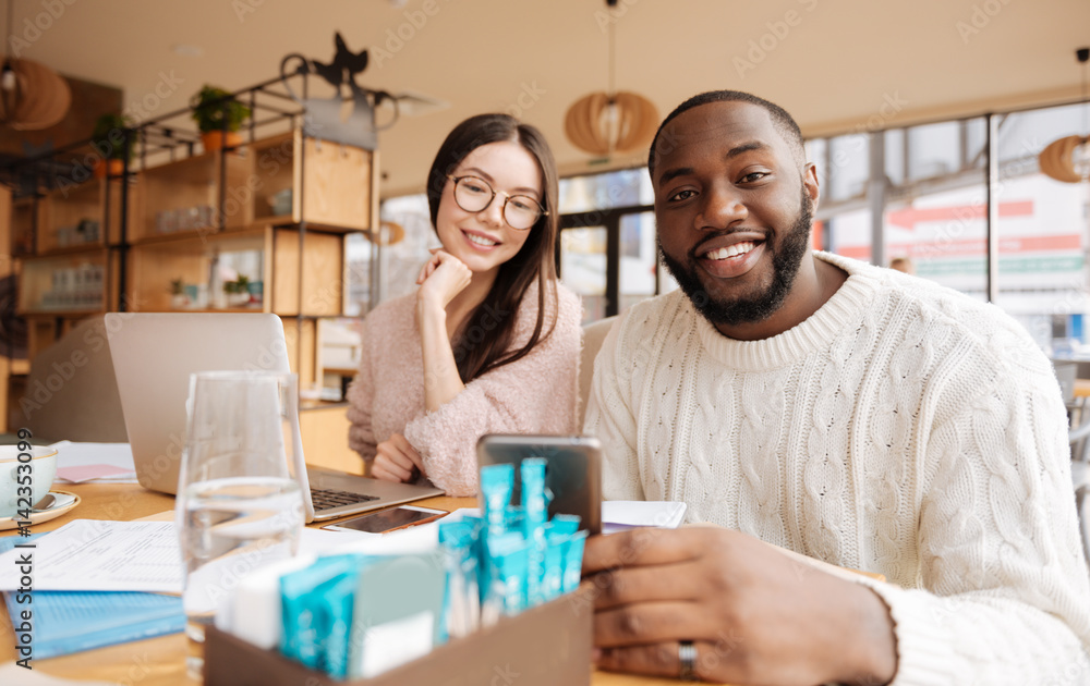 Fototapeta premium Couple of youngsters studying at cafe