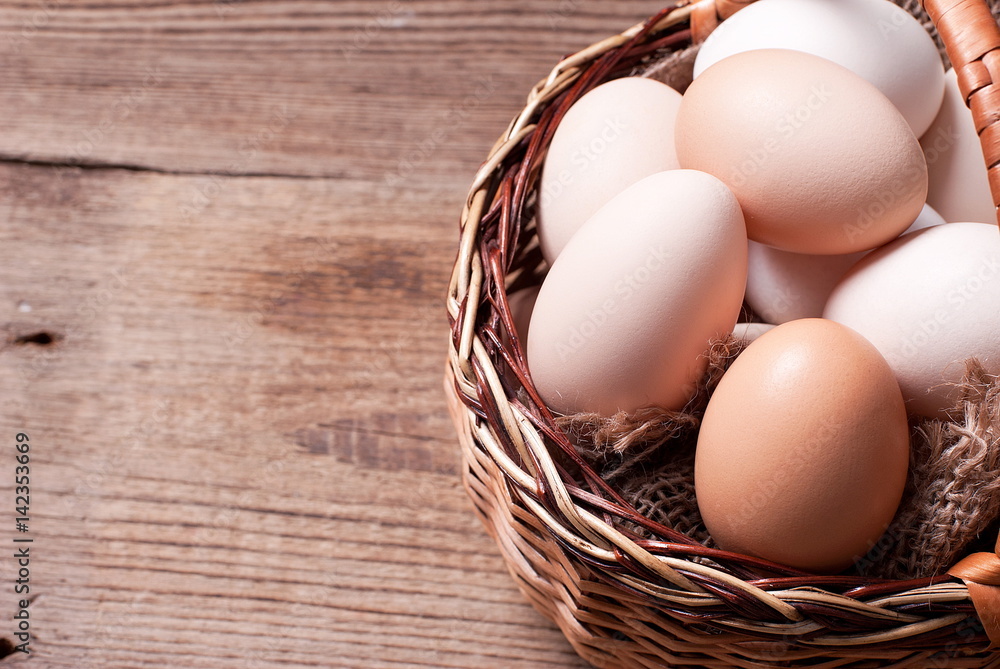 Eggs in a basket on a table, top view Eggs in a basket on a table, top view