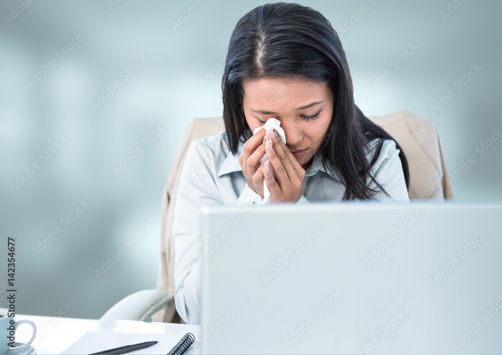 Sad woman crying on laptop with bright background Sad woman crying on laptop with bright background