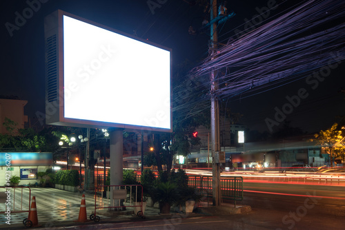 Blank Billboard on City Street at Night