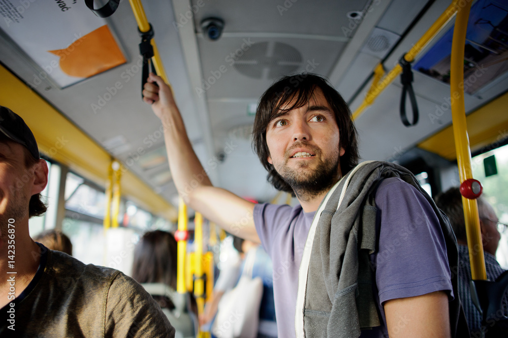 The young bearded man in the city bus. The young bearded man in the city bus.