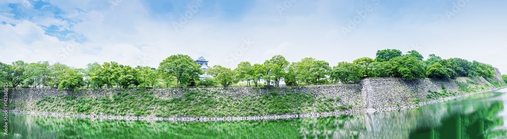 Panoramic view of Osaka Castle and walls surrounded by river Panoramic view of Osaka Castle and walls surrounded by river