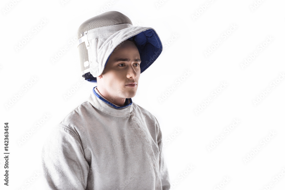 portrait of serious fencer in mask and uniform for training on white portrait of serious fencer in mask and uniform for training on white