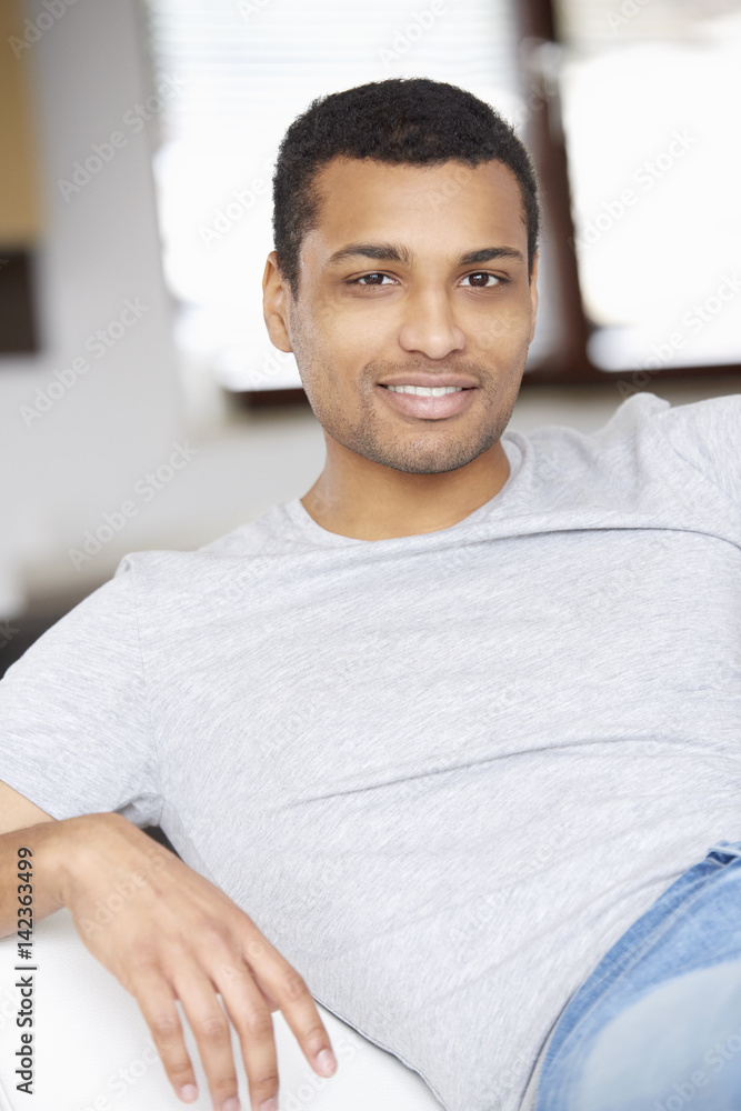 Weekend at home. Shot of an African American young man relaxing on the sofa. Weekend at home. Shot of an African American young man relaxing on the sofa.