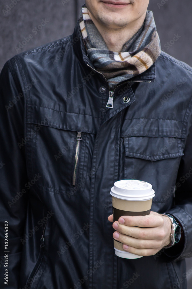 Man holds a cup of coffee Man holds a cup of coffee