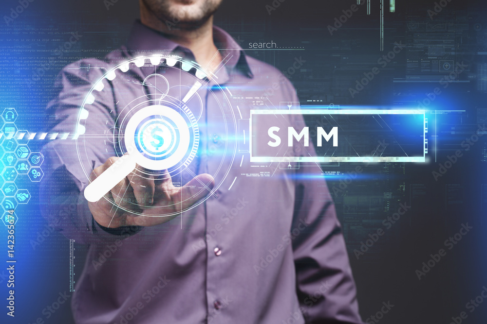 Business, Technology, Internet and network concept. Young businessman working on a virtual screen of the future and sees the inscription: SMM Business, Technology, Internet and network concept. Young businessman working on a virtual screen of the future and sees the inscription: SMM