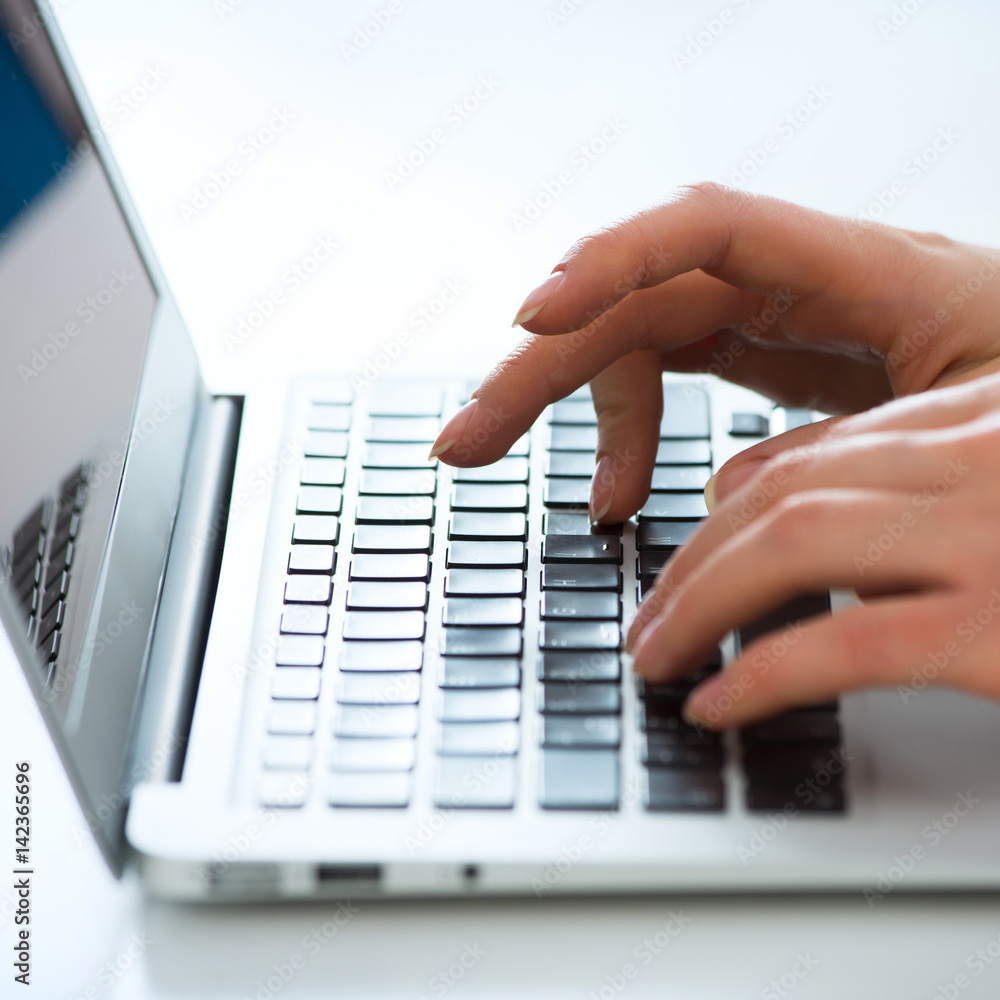 Closeup of businesswoman typing on laptop computer Closeup of businesswoman typing on laptop computer