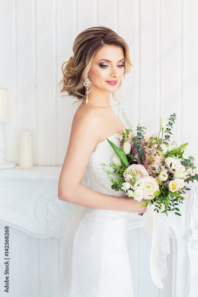 Fashion portrait of a beautiful bride with a wedding bouquet