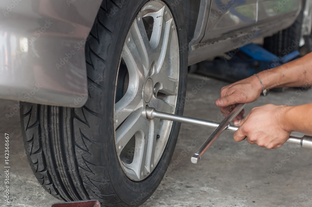 Fototapeta premium Unidentified worker change tire, movement action.