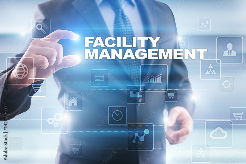 Businessman selecting facility management on virtual screen.