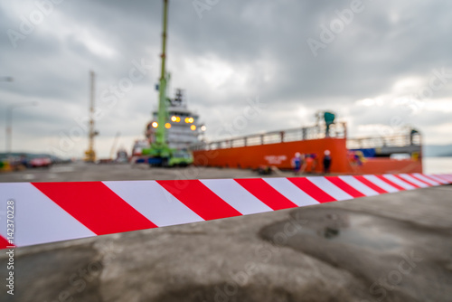 work zone safety.under construction and caution advertisements.the machine is working.No entry at Container ship in docks © Theerawat