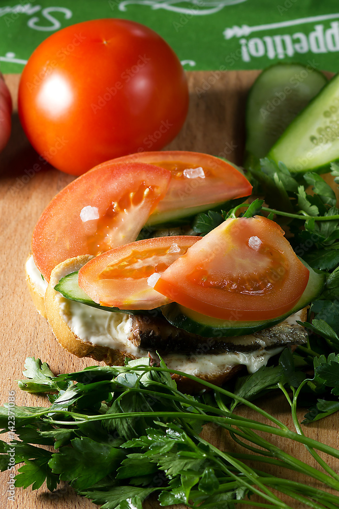 Sandwich with sprats,garlic,sauce,sea salt,cucumber and tomato Sandwich with sprats,garlic,sauce,sea salt,cucumber and tomato