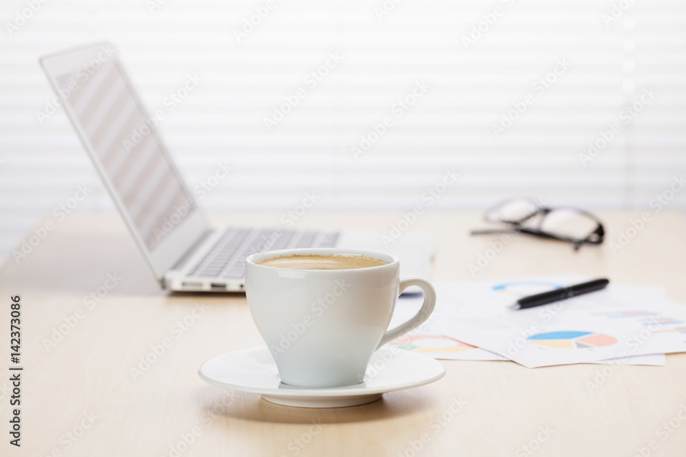 Office workplace with coffee, laptop and supplies Office workplace with coffee, laptop and supplies