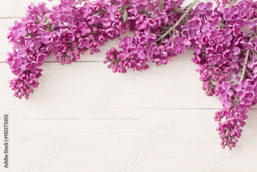 The beautiful lilac on a wooden background
