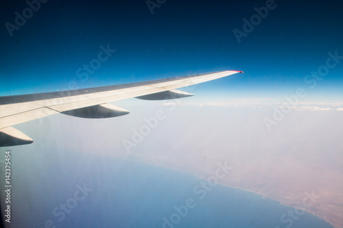 Wing of aeroplane flying in the sky