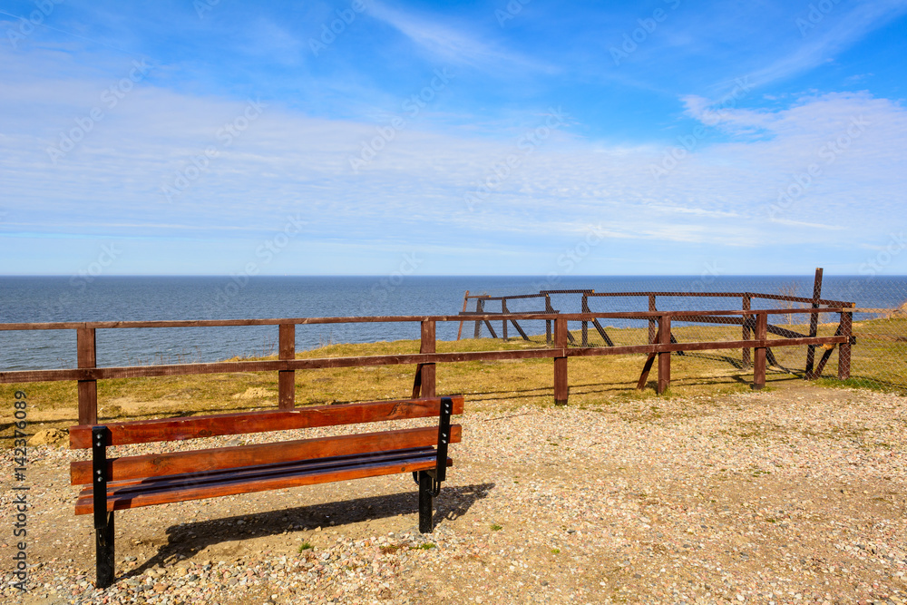 Bench with beautiful view of the Baltic Sea under blue sky. Jastrzebia Gora. Poland. Bench with beautiful view of the Baltic Sea under blue sky. Jastrzebia Gora. Poland.