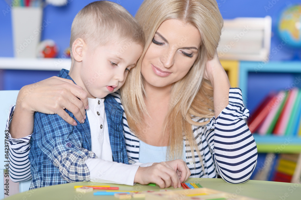 Mother helping her son with lessons