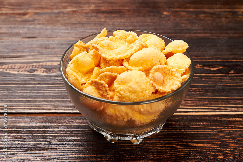 Cornflakes on wooden background. How to lose weight. Cornflakes on wooden background. How to lose weight.