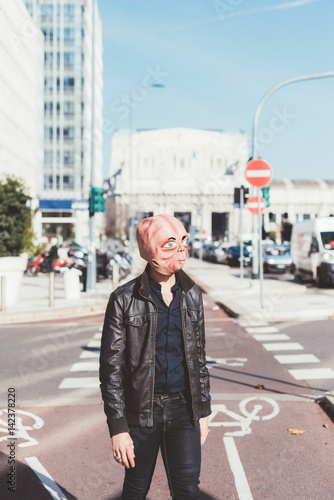 Two man wearing alien mask outdoor in the city - martian, carnival, halloween concept