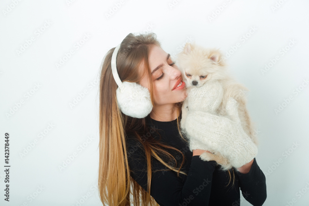 sexy pretty happy girl with small pomeranian dog in earmuffs sexy pretty happy girl with small pomeranian dog in earmuffs