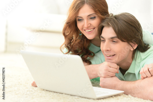 Beautiful young couple with a laptop