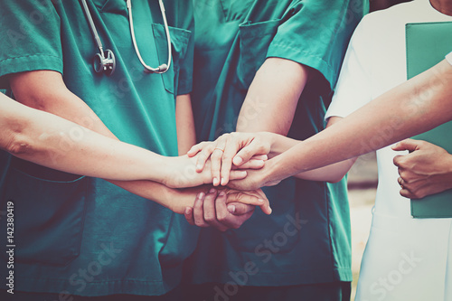 Doctors and nurses coordinate hands. Concept Teamwork photo