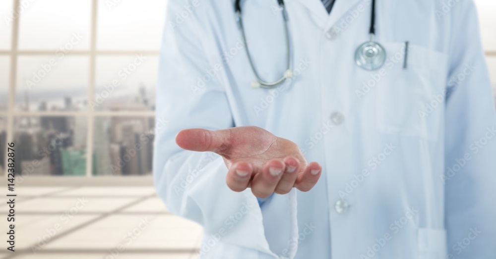 Doctor mid section with hand out against blurry window Doctor mid section with hand out against blurry window