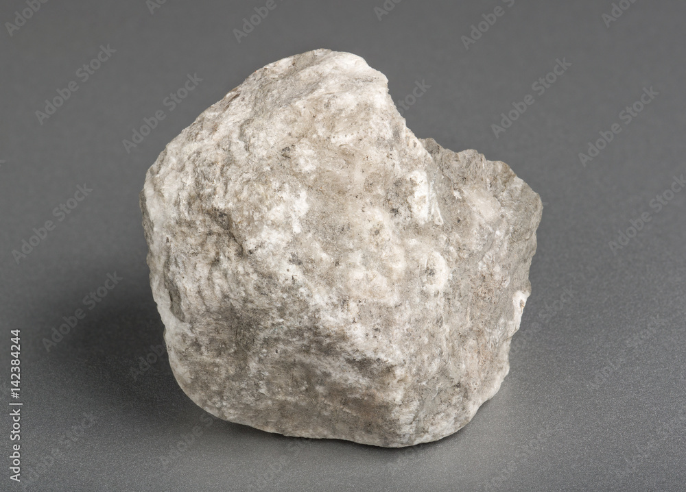 Mineral gypsum on gray background. Gypsum is a soft sulfate mineral composed of calcium sulfate dihydrate. Mineral gypsum on gray background. Gypsum is a soft sulfate mineral composed of calcium sulfate dihydrate.