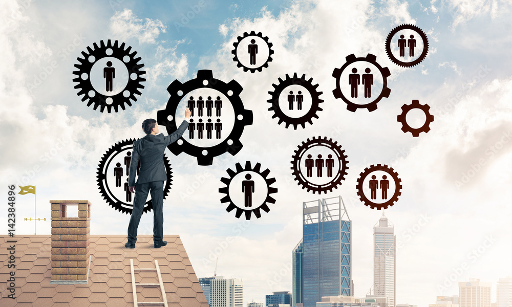 Businessman on house roof presenting teamwork and connection con Businessman on house roof presenting teamwork and connection con