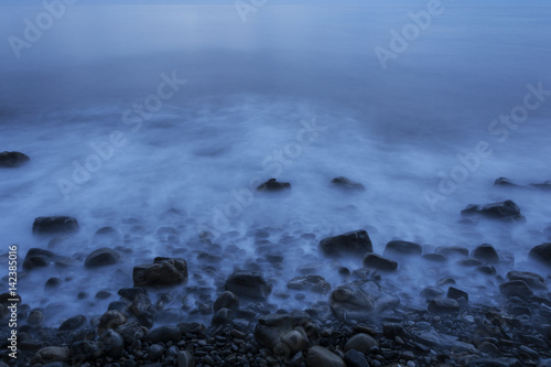 Sea stones on the beach after sunset