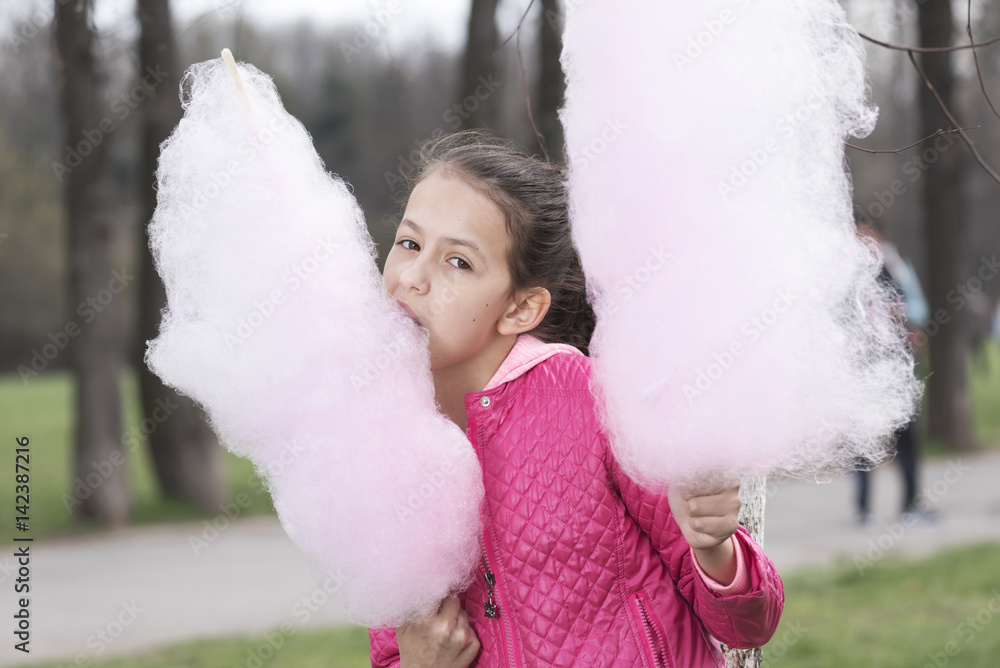 Sweet girl with candy floss in the park Sweet girl with candy floss in the park
