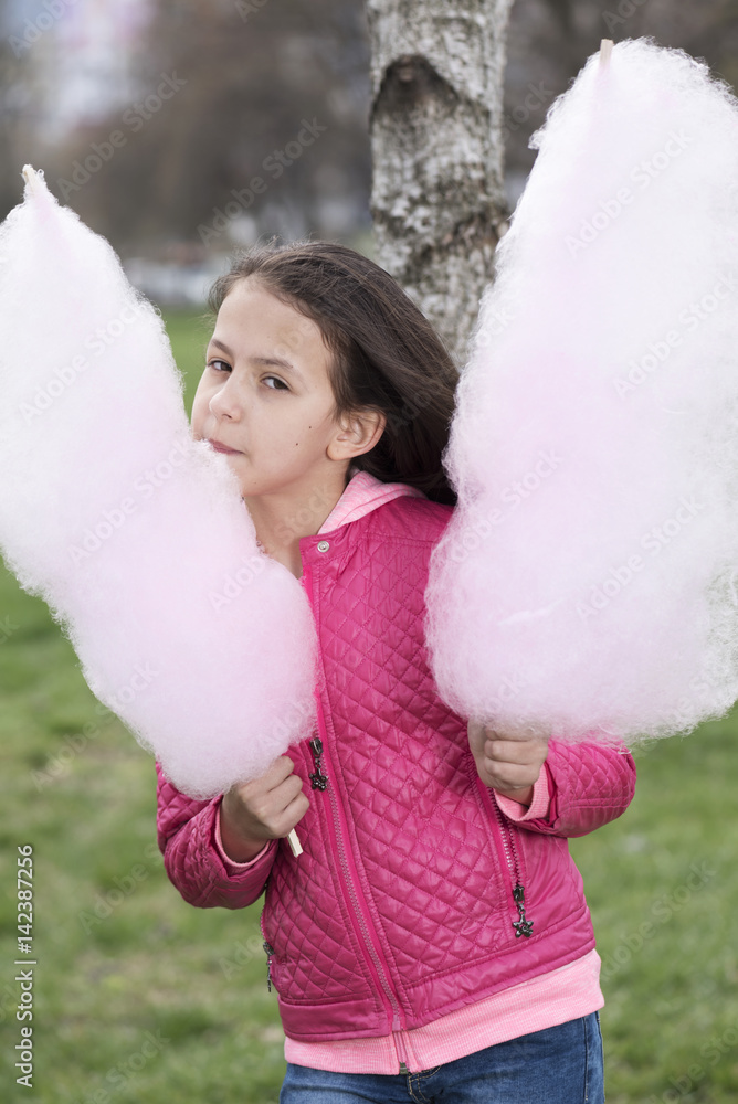 Vertical picture of a girl with cotton candy Vertical picture of a girl with cotton candy