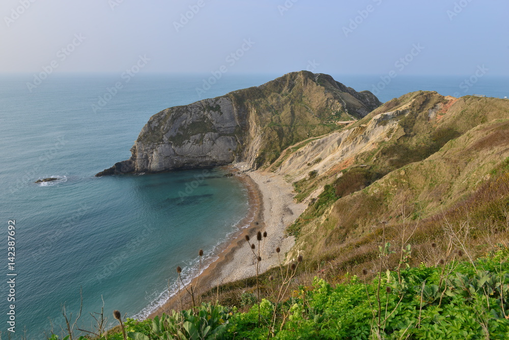 Beach and cliff areas near Durdle door in Dorset.
Beach and cliff areas near Durdle door in Dorset.