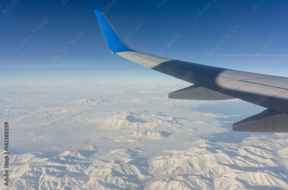 Plane wing and mountains in a beautiful landscape Plane wing and mountains in a beautiful landscape