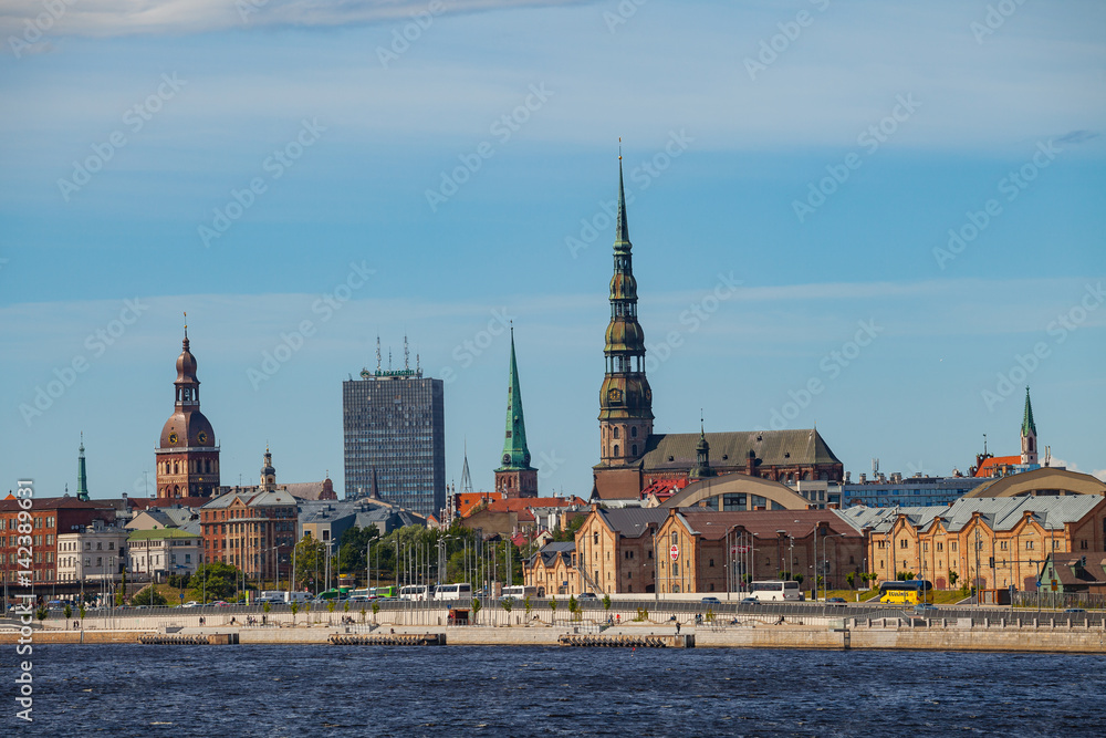 RIGA, LATVIA - 12 JUN 2016: Old town summer day view with Daugava river RIGA, LATVIA - 12 JUN 2016: Old town summer day view with Daugava river
