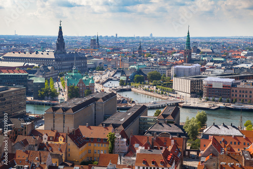 Aerial view of Copenhagen red roofs and canal. Churches and palaces of Danish capital.
