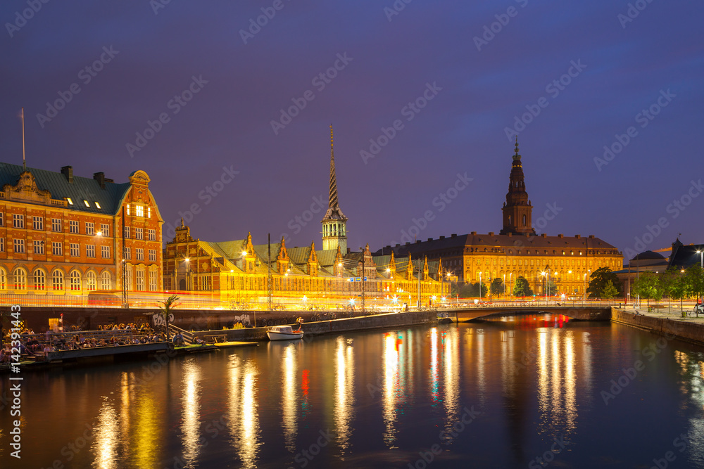 Night view on Christiansborg Palace and Stock Exchange building over the channel in Copenhagen.