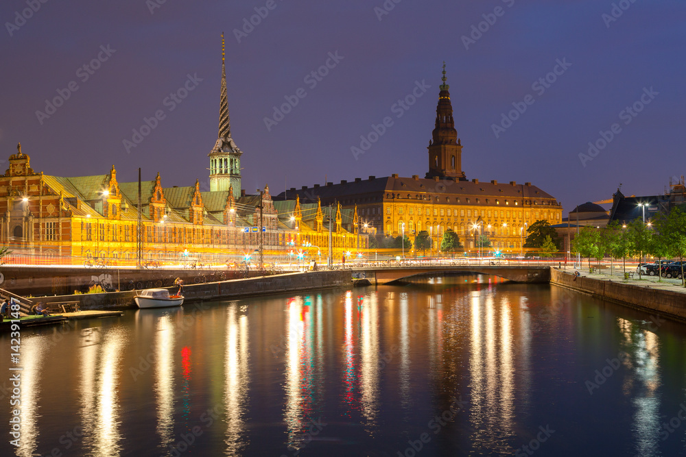 Night view on Christiansborg Palace and Stock Exchange building over the channel in Copenhagen.