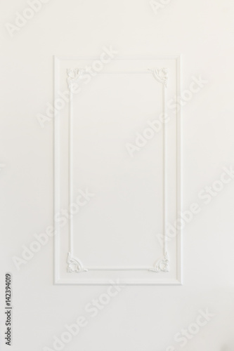 White wall decorated with stucco and molding in the style of Renaissance, Baroque.