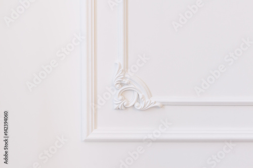 White wall decorated with stucco and molding in the style of Renaissance, Baroque.