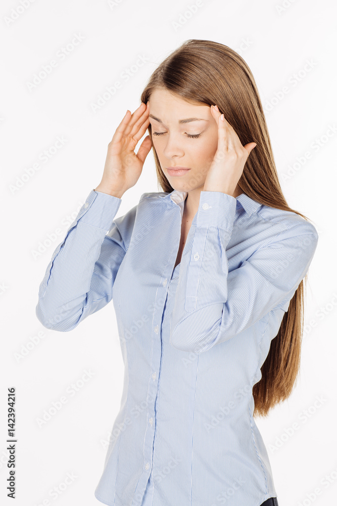 unhappy young woman holding hands in head. human emotion expression and lifestyle concept. image on a white studio background. unhappy young woman holding hands in head. human emotion expression and lifestyle concept. image on a white studio background.