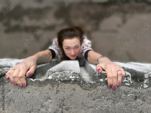 Girl hanging off the roof