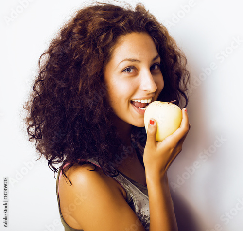 pretty young real tenage girl eating apple close up smiling photo